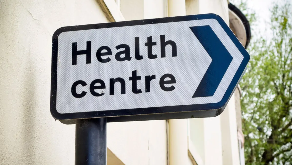 A directional sign pointing to a local health centre