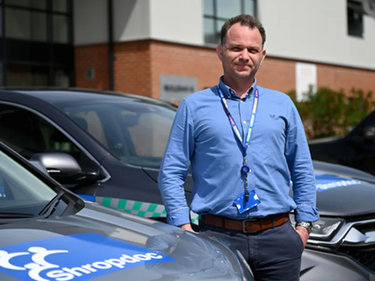 A member of the Shropdoc team beside a branded response car